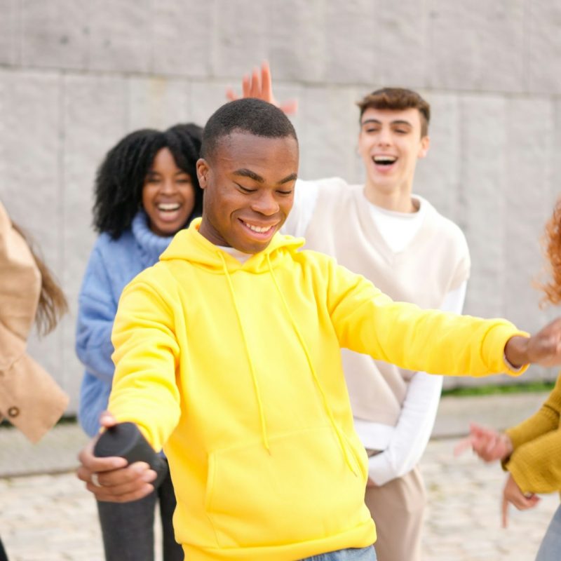 Multi-ethnic happy friends dancing excited in the city